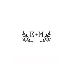 the word e - m is written in black ink on a white background with leaves