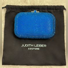 Meet A Clutch With Real Icon Status. Our Oval-Shaped Slide Lock Clutch Dazzles In Full Handset Crystal And Is Ready For Its Close Up On The Red Carpet, At The Gala Or Simply On A Spectacular Saturday Night. This Model Is For Sale On The Judith Leiber Website In Other Colors. - Encrusted With Blue Faceted Crystals - Special Edition Color: Capri Blue - Silver Toned Metal Hardware - Sliding Closure With Crystals - Metallic Leather Interior - Removable Silver Chain - Imported - Includes: Judith Leib Luxury Blue Pouch Clutch, Blue Clutch Evening Bag, Luxury Blue Rectangular Clutch, Blue Clutch Evening Bag With Dust Bag, Blue Luxury Evening Bag With Removable Pouch, Luxury Blue Evening Bag With Removable Pouch, Blue Pouch Clutch For Formal Occasion, Designer Blue Evening Bag, Luxury Blue Rectangular Evening Bag