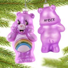 an ornament shaped like a teddy bear and another animal hanging from a christmas tree