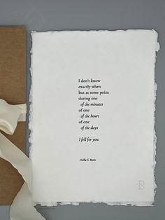 a piece of paper with a poem written on it next to a brown envelope and white ribbon