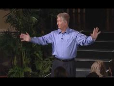 a man standing in front of stairs with his hands out