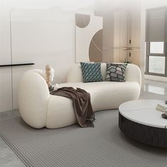 a living room with a white couch and round coffee table