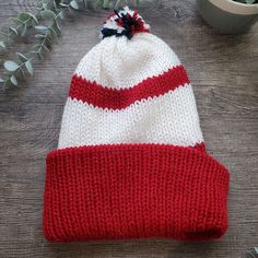 red and white striped knit hat Striped Beanie Hat One Size, Striped Beanie Hat, One Size Fits Most, Red Beanie Hat, One Size Fits Most, Winter Striped Hats One Size Fits Most, Striped Winter Hats One Size Fits Most, Casual Warm Red Beanie, Casual Striped Cap, White Winter Beanie Cap, White Knit Beanie Bonnet