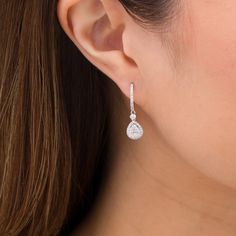 Elevate your dressy looks with these elegant multi-diamond teardrop hoop earrings. Created in 14K white gold Each drop showcases a teardrop-shaped composite of diamonds wrapped in a diamond-lined frame. A shimmering diamond connects the dangle to the diamond-adorned hoop. These 1 cts. t.w. diamond earrings secure with hinged backs. Teardrop Diamond Earrings, White Diamond-cut Teardrop Earrings, White Diamond Cut Teardrop Earrings, Pear-shaped Diamond Earrings In Fine Jewelry Style, White Diamond Accented Pear-shaped Teardrop Earrings, White Diamond-accented Teardrop Earrings, White Pear-shaped Teardrop Earrings With Diamond Accents, White Gold Pear-shaped Teardrop Earrings In Fine Jewelry Style, Diamond White Pear-shaped Teardrop Earrings