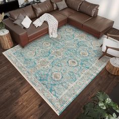 a living room with a large green rug on the floor and brown leather couches