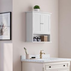 a white bathroom sink sitting under a cabinet