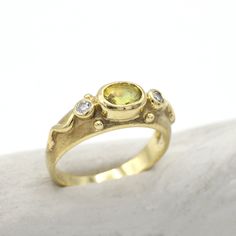 Vintage 14kt yellow gold ring. Made with genuine 14kt yellow gold with a Center stone of a cabochon yellow citrine. On both sides of the citrine are round diamonds approx. .06ct each for a total of approximately. .12cttw All the stones are set in a bezel setting. The top of the ring has a nice matte gold finish to it. Great ring for everyday wear. Ring is currently a size 6.25 but can be adjusted upon request. Center stone is a genuine Yellow citrine stone approx. 1 ct. Ring weighs approx. 4.30 14k Gold Yellow Sapphire Ring, Oval Yellow Sapphire Ring In Yellow Gold, Yellow Gold Citrine Oval Diamond Ring, Unique Gold Sapphire Ring With Gemstone Accents, Yellow Gold Citrine Diamond Ring With Accents, Oval Citrine Diamond Ring In Yellow Gold, Yellow Gold Diamond Ring With Citrine Accents, Heirloom Yellow Gold Rings With Yellow Sapphire, Round Yellow Sapphire Ring With Accent Stones