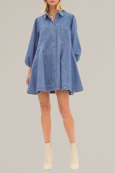 introducing our button up denim dress, a timeless addition to your wardrobe. made with durable denim material and featuring a collared neckline, this dress exudes a classic and timeless look. its practical pockets and elasticized cuffs make it both stylish and functional. perfect for any occasion. 100% cotton model is wearing a size small model is 5'10" Medium Wash Cotton Dress With Buttoned Pockets, Denim Blue Dress With Button Closure For Work, Spring Denim Blue Dress With Buttoned Pockets, Spring Denim Blue Dresses With Buttoned Pockets, Denim Button-up Mini Dress For Work, Button-up Denim Mini Dress For Work, Denim Blue Cotton Dresses With Buttoned Pockets, Chic Collared Denim Blue Dress, Denim Blue Knee-length Dress With Buttoned Pockets