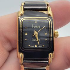 Vintage Vivani Gold Tone & Black Gunmetal Rectangular Ladies Bracelet Watch  This watch makes a great everyday piece.  The black & gold-tone watch has a bracelet band that secures with a snap-lock clasp.  The rectangular watch has black face with a gold-tone dial & hands.  This piece is in great vintage condition with some wear near the lugs.  A NEW battery was inserted & the watch works perfectly.   Dimensions: Band: 7 1/2" long; Case: 19 x 23 mm Clasp: Snap Lock Markings:  Vivani, Quartz, Japan Movt, Accutime Watch Corp. NY Condition: Great - some wear near lugs, new battery All of my shop items are pre-owned vintage.  All pieces should be expected to have some vintage wear unless otherwise stated.   Great for the vintage & costume jewelry lover!  Be sure to check out our other vintage j Rectangular Watch, Ladies Bracelet Watch, Ladies Bracelet, Snap Lock, Women Wrist Watch, Vintage Costume Jewelry, Vintage Wear, Jewelry Lover, Vintage Costumes