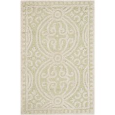 a green and white rug with an intricate design on the bottom, in front of a white background