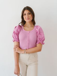 Enter true charm in the "Sierra Shine Top!" This feminine top is such a fun and vibrant top for the summer! It has contrasting fabrics on the sleeves and base that make it effortlessly appealing! Its soft knit base has a button up closure that is complemented by blouse sleeves! Fabric: self 50% viscose, 28% polyester, 22% nylon/ contrast 100% cotton Care: Hand wash cold, do not bleach, line dry, iron low if needed, do not tumble dry Model is wearing size small Measurements for size Small: should Spring Stretch Tops With Buttons, Summer Stretch Tops With Buttons, Stretch Summer Tops With Buttons, Stretch Tops With Buttons For Summer, Feminine Fitted Knit Top For Day Out, Trendy Puff Sleeve Top For Day Out, Pink Knit Top With Short Sleeves, Pink Knit Tops With Short Sleeves, Pink Knit Short Sleeve Tops