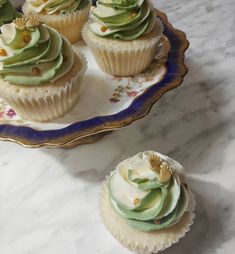 cupcakes with green frosting on a plate