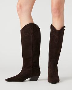 The DOLLIE Western boot offers a sleek and stylish design with a square toe. Experience comfort and durability with every step. Elevate your wardrobe with this timeless and versatile statement piece. 1.75 inch heel height Size 6 measurements: 15 inch shaft circumference, 13 inch shaft height Size 8 measurements: 16 inch shaft circumference, 14 inch shaft height Size 10 measurements: 17 inch shaft circumference, 14.75 inch shaft height Suede upper material Textile and synthetic lining Synthetic s Luchesse Boots Women, Luchesse Boots, Football Game Outfit, 2024 Style, Western Boots Women, Trending Boots, Western Boot, Gaming Clothes, Fall 2024