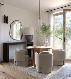 a living room filled with furniture and a large mirror on the wall over a table