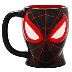 a spider - man mug with red eyes on it's face is shown in front of a white background