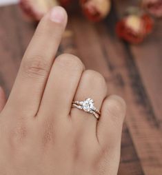 a woman's hand with a diamond ring on it