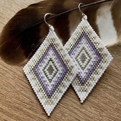 Lightweight Southwestern beaded earrings in winter hues.  These carefully handmade earrings are created with over 1,000 Miyuki Delica seed beads. Using a mix of opaque, mattes, transparent mattes, silk satin, and matte metallic beads in shades of white, silvers, and violets.  With Sterling Silver Earwires. Very lightweight!! approximate measurements: from top of ear wire to bottom of beadwork: 2 3/4 inches at the widest part of woven tops:   1 1/2  inches ---- also available in desert hues: http White Artisan Jewelry With Tiny Beads, Artisan White Jewelry With Tiny Beads, Handmade White Bohemian Jewelry, White Handwoven Drop Earrings, White Handmade Bohemian Jewelry, Nickel Free White Bohemian Earrings, White Round Bead Southwestern Earrings, Nickel-free White Bohemian Earrings, White Artisan Beaded Dangle Earrings