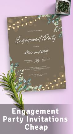 an engagement party card with greenery and lights on it, next to a plant