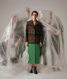 a woman standing in front of plastic covering her face