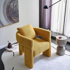 a yellow chair sitting on top of a white rug