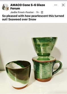 two green cups sitting next to each other on top of a white table with the words amaco cone 5 - 6 glaze