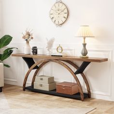 a living room with a couch, table and clock on the wall above it's shelf