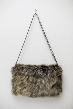 Goat fur clutch bag in dark olive colour unfolds to reveal two zip pockets and leather lining. Its very nice bag for going out . A delightful shoulder bag possible to wear like a clutch.. Dark silver tone chain shoulder strap. Colour-olive green Measures : ( folded out ) Length 32 cm 12,5 ins Width 27 cm 10,6 ins Chain strap 70 cm 27,5 ins On pictures with model shows grey colour bag. Dusty pink: https://www.etsy.com/listing/225696835/folded-fur-clutch-bag-lambskin-shoulder?ref=shop_home_active_ Winter Evening Shoulder Bag With Faux Fur Lining, Winter Evening Bags With Faux Fur, Winter Evening Bag In Faux Fur, Rectangular Faux Fur Evening Bag, Winter Evening Bags In Faux Fur, Evening Rectangular Bag With Faux Fur Lining, Fur Clutch Bag, Olive Colour, Fur Clutch