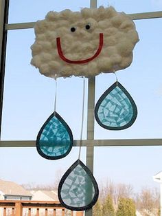 a window with some clouds and raindrops hanging from it