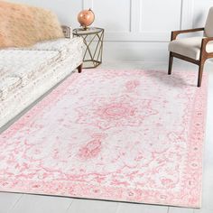 a pink and white rug in a living room