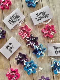 several small birthday bows with happy birthday tags on them