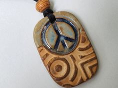 Peace Sign Ceramic Bead Necklace, Hippie Necklace * Light weight and with adjustable cording * 1 7/8" x 1 1/4"  * 10 grams  *3mm hole * Fired to cone 6 or 2,232 degrees for glaze richness and durability. Bohemian Peace Sign Necklace For Gift, Hippie Style Necklace With Round Pendant For Gift, Hippie Jewelry With Adjustable Cord For Gift, Hippie Jewelry With Adjustable Cord As Gift, Hippie Style Jewelry With Adjustable Cord For Gifts, Hippie Style Jewelry With Adjustable Cord As Gift, Adjustable Peace Sign Necklace, Adjustable Peace Sign Necklace As Gift, Symbolic Round Bead Adjustable Necklaces