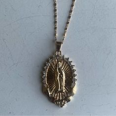 This Virgin Mary, Pendant Necklace Is Perfect For Layering W/ Your Favorite Chains For The Ultimate Mob-Wife & Y2k Aesthetic And Is Said To Offer Protection & Healing Energies, Making It A Thoughtful Gift For Those Seeking Love & Guidance. It’s Its Beauty And Significance Are Timeless. Measurements Are Included In Listing Pictures. New Without Tags. From Both A Pet Free & Smoke Free Home. Gold Chain Pendant, Virgin Mary Pendant, Virgin Mary Necklace, Angel Necklace, Mob Wife, Catholic Jewelry, Gold Chain With Pendant, Hail Mary, Chain Pendant