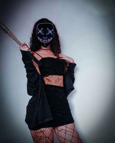 a woman wearing a mask and holding a baseball bat