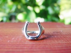 "This BEAUTIFUL Handcrafted .925 Sterling Silver Horseshoe ring - Equestrian Jewelry - Horseshoe Jewelry - for everyday wear or going out on the town. Great for horse lover gifts, Equestrian gifts, Horse gifts. *Sterling Silver * Measument of Horseshoe : 5/8\" by 1/2\" * Size 6-11 * 925 Sterling Silver I have many more unique Handcrafted Sterling Silver Jewelry Pieces that I will be selling here on Etsy so check back!! You will be happy you did. Go back to my home page: https://www.etsy.com/shop Equestrian Ring, Horse Lover Gifts, Equine Jewelry, Horseshoe Jewelry, Horse Ring, Horseshoe Ring, Horseshoe Pendant, Equestrian Jewelry, Equestrian Gifts