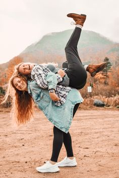 a woman is doing a handstand on the ground with her feet in the air