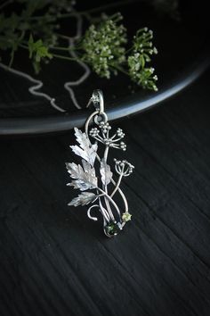 ITEM DESCRIPTION: The size H 5 cm x W 3 cm (2 x 1 1/3 inch). Weight - 5 g. You can buy it with a silver chain or without it. Even simple plants look very elegant. I made one of sterling silver, pretty green tourmaline, and peridot. This unique botanical jewelry looks like a real treasure of wild forest. It is really worthy of being in your precious collection. Expect many compliments on this! This handmade necklace will come to you in a gift box - ready for gifting. The parcel will be sent durin Botanical Sterling Silver Jewelry Gift, Botanical Silver Jewelry With Birth Flower, Silver Nature-inspired Metal Jewelry, Green Sterling Silver Necklace With Flower Pendant, Nature-inspired Silver Metal Jewelry, Nature-inspired Sterling Silver Birth Flower Necklace, Nature-inspired Silver Metal Necklace, Nature-inspired Metal Pendant Necklace, Elegant Silver Jewelry With Birth Flower