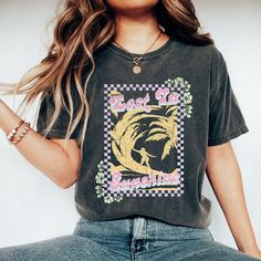 Looking for a cute versatile top to wear? Make sure to grab one of our Graphic tees! This soft and comfortable graphic tee is the perfect top for any outfit. It can be paired with biker shorts, jeans, or even a simple skirt/dress! This tee is true-to-size, so be sure to order your regular t-shirt size! If you are looking for a more oversized look, make sure to size up! Sequin Shorts, Floral Jumpsuit, Cable Knit Cardigan, Casual Fit, Sweater Blouse, Casual Fits, Vintage Look, Heavy Weight, Air Dry