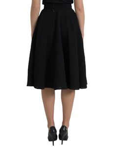 This Dolce & Gabbana skirt has a knee-length cut and sits high on the waist. Made in Italy with 80% virgin wool, 11% silk, and 9% nylon, this black skirt features a back zipper closure. Model: High waist skirt Color: Black Material: 80% Virgin Wool 11% Silk 9% Nylon Back zipper closure Flare Made in Italy