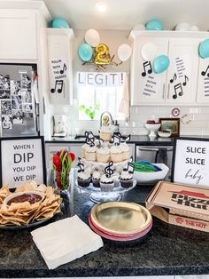 a kitchen counter topped with lots of food and desserts on top of each other