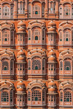 the facade of an old building with many windows and balconies on each side