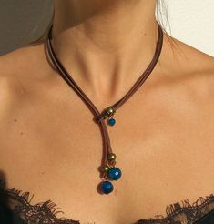 "Lariat necklace, leather necklace, stone necklace, necklace for woman belong to bohemian jewelry as well as boho jewelry. A gemstone jewelry piece carefully designed and crafted by EndiaDesign. Show off a bohemian style with this unique leather necklace made of high quality cow leather, agates stones in blue colour and a beads in antique bronze tone. You could wear this original gemstone necklace on any occasion, formal or casual, making you look super chic and cute. Agate Healing Properties ♥ Elegant Lariat Necklace With Adjustable Cord, Festival Lariat Necklace With Natural Stones, Bohemian Lariat Necklace As Gift, Adjustable Cord Long Necklace, Bohemian Lariat Necklace With Sliding Knot, Bohemian Lariat Choker Necklace, Unique Adjustable Lariat Necklace, Unique Adjustable Length Necklaces, Unique Necklaces With Adjustable Length