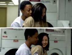 two people are hugging each other in front of a washing machine