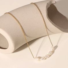 The Cinco Perlas Necklace features dainty, fresh water pearls in an elegant, minimalist style. With 18k gold plating and a hypoallergenic design, this necklace is both luxurious and practical, staying tarnish-free for all-day wear. Add a touch of sophistication to any outfit with this stunning piece. 16 inches + 2 inch extender Minimalist Gold Plated Pearl Necklace With Adjustable Chain, Minimalist Gold-plated Pearl Necklace With Adjustable Chain, Minimalist Gold-plated Pearl Pendant Necklace, Simple Gold Pearl Necklace With Clavicle Chain, Minimalist Gold Plated Pearl Drop Necklace, Minimalist Gold-plated Pearl Drop Necklace, Minimalist Gold Plated Pearl Chain Necklace, Minimalist Gold-plated Pearl Chain Necklace, Gold Pearl Necklace With Simple Chain