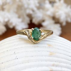 Estate/ vintage 14KT yellow gold ring with oval, genuine emerald + diamond accents. Stunning deep, green color on this emerald. Emerald is the birthstone for May babies + this ring makes a fantastic gift! Size 6.5 Weight: 2.10g Genuine, oval-cut, emerald measures: 6.5mm x 5mm .65~ .70 CT natirual diamonds (6) round diamonds; SI/I clarity; I color Stamped 585 (14K) Excelent estate condition Fine Jewelry Emerald Oval Cabochon Ring For May Birthstone, Heirloom Oval Cabochon Emerald Ring, Oval Emerald Ring With Diamond Accents For May Birthstone, Heirloom Oval Emerald Ring, Oval Emerald Ring In Gold, Luxury Emerald Ring With Oval Cabochon Center Stone, Emerald Ring With Oval Cabochon Center Stone, Emerald Oval Cabochon Ring With Center Stone, Oval Cabochon Emerald Ring With Center Stone