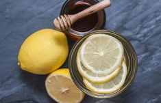 lemons and honey sit next to each other on a table