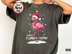 🧥 For a relaxed, oversized fit, size up 1-2 sizes based on the size chart. 💤 For a "Sleep Shirt" or dress-like look, size up 3 sizes for a more dramatic fit. 📏 Check the size chart carefully to ensure you get the ideal fit you're after! This Christmas flamingo T-shirt features a festive flamingo wearing a Santa hat and holiday lights. The fun graphic tee is perfect for adding a touch of humor and holiday cheer to any wardrobe. Whether you're attending a Christmas party or just looking for a unique holiday top, this flamingo shirt is sure to make a statement. Product Features: Fabrication: Medium fabric (6.1 oz/yd² (206.8 g/m. Garment-dyed fabric. 100% ring-spun cotton Fit: Relaxed fit Sizing: Unisex Sizing Label: Sewn-in twill label PRODUCTION TIME: 1-3 days (Usually 2 days) SHIPPING TI Christmas Flamingo, Flamingo Shirt, Flamingo Christmas, Holiday Tops, Cool Graphic Tees, Sleep Shirt, Holiday Lights, Fit Check, Santa Hat