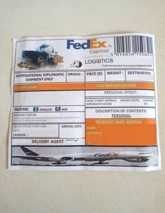 a fed ex airline ticket sitting on top of a white table next to a wall