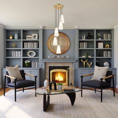 a living room filled with furniture and a fire place in the middle of it's wall