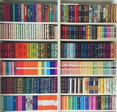 a book shelf filled with lots of colorful books on top of white shelves next to each other