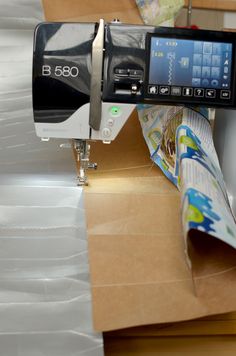 a sewing machine sitting on top of a piece of cardboard